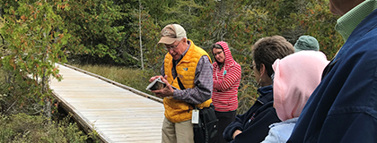Volunteer with a group on a guided hike.