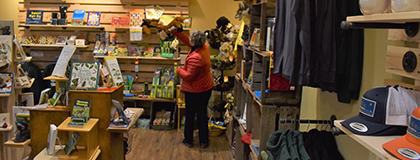 Person picking up an item in the Nature Store.
